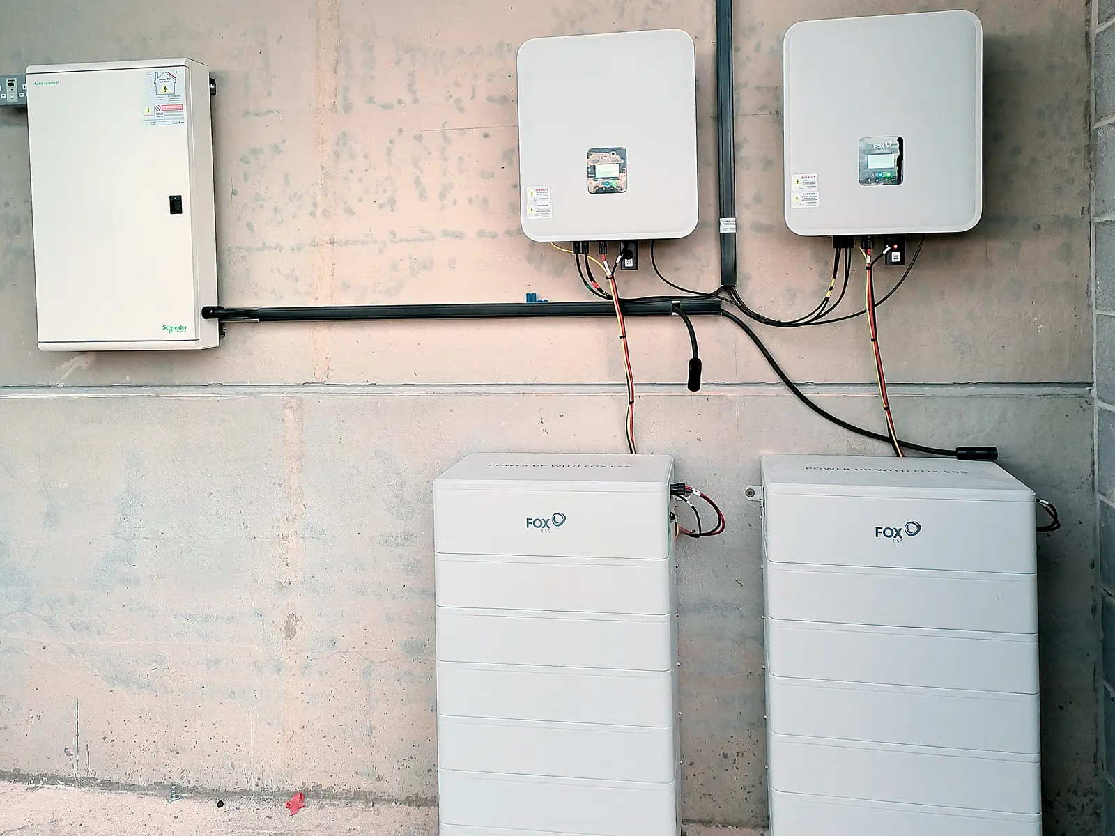 Two Fox ESS battery stacks installed beneath their hybrid inverters