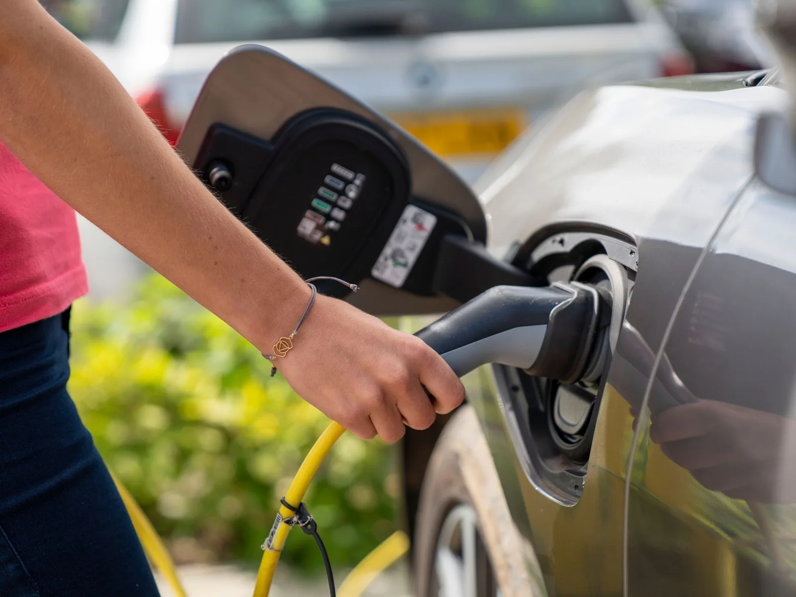 Plugging an electric car in to charge