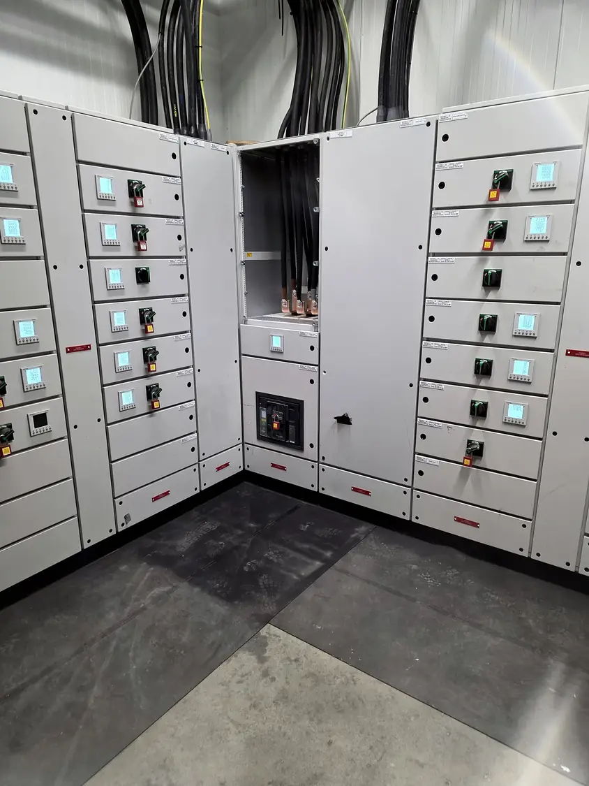 LV switchboard: incoming cables terminated in the open section, ACB below and padlocked outgoing switches · Coldstar Refrigeration