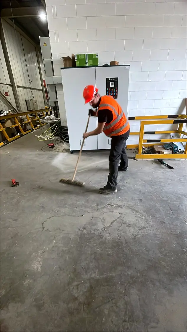 Operative sweeping the floor in front of the finished panel