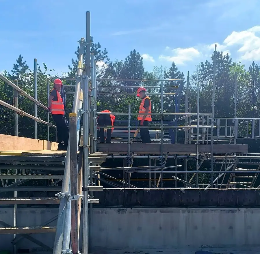 Operatives on the scaffold stair tower at the roof edge