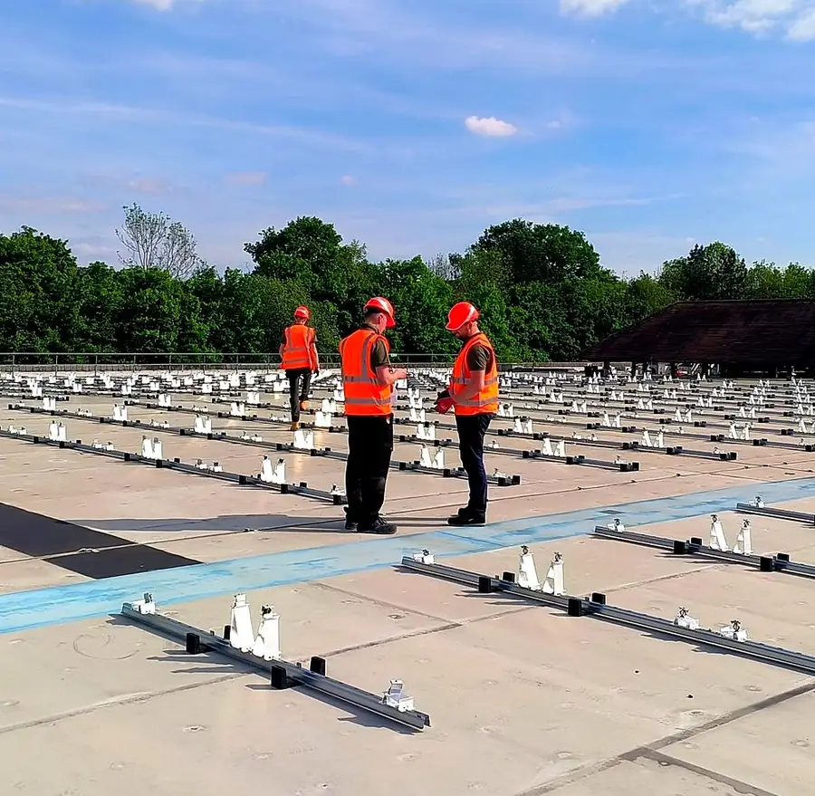 Operatives among the mounting rails set out across the roof