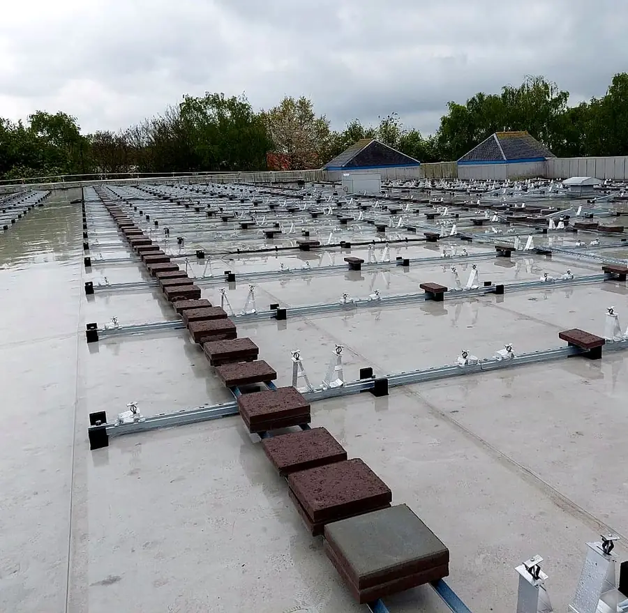 Mounting rails weighted with concrete ballast blocks