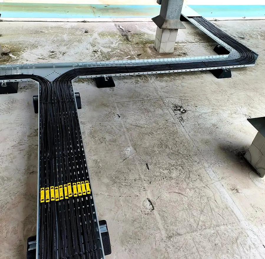 Labelled DC cables at a tray junction on the roof