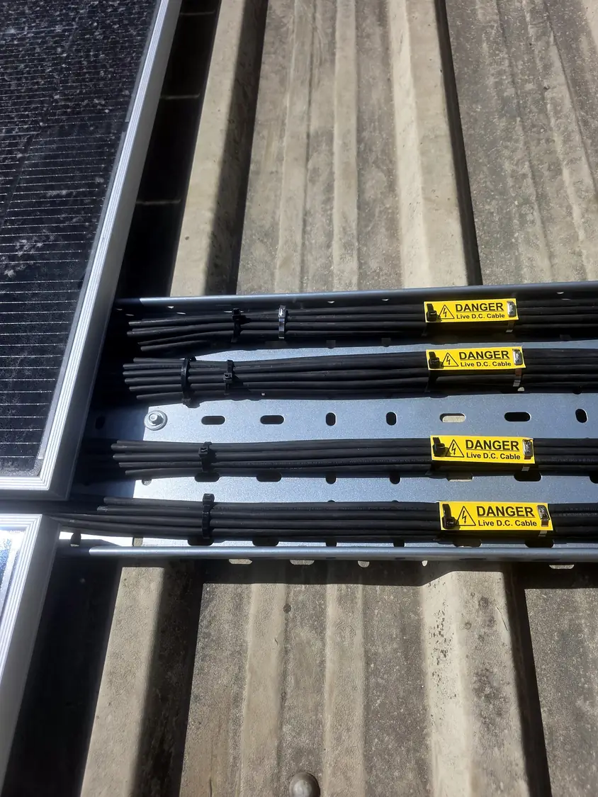 DC cables in tray labelled “Danger – Live D.C. Cable”