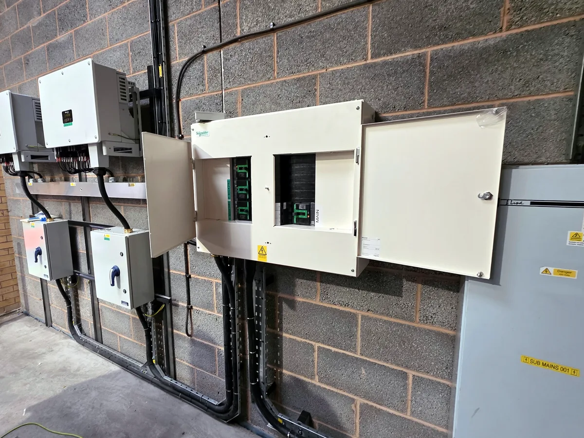 Inverters, AC isolators and the main switchboard, with cables run in tray to the board