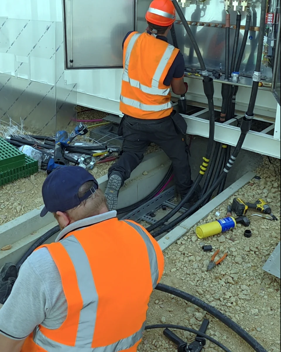Pulling large cables through the trough and into the panel